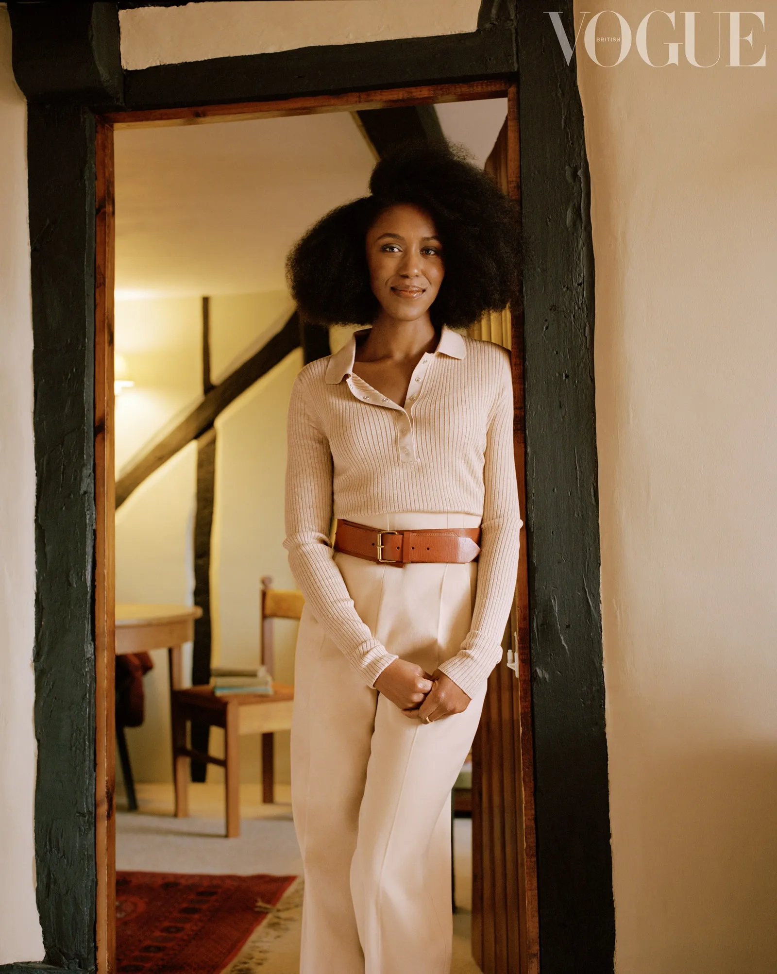 Natasha Brown stands leaning against a doorway